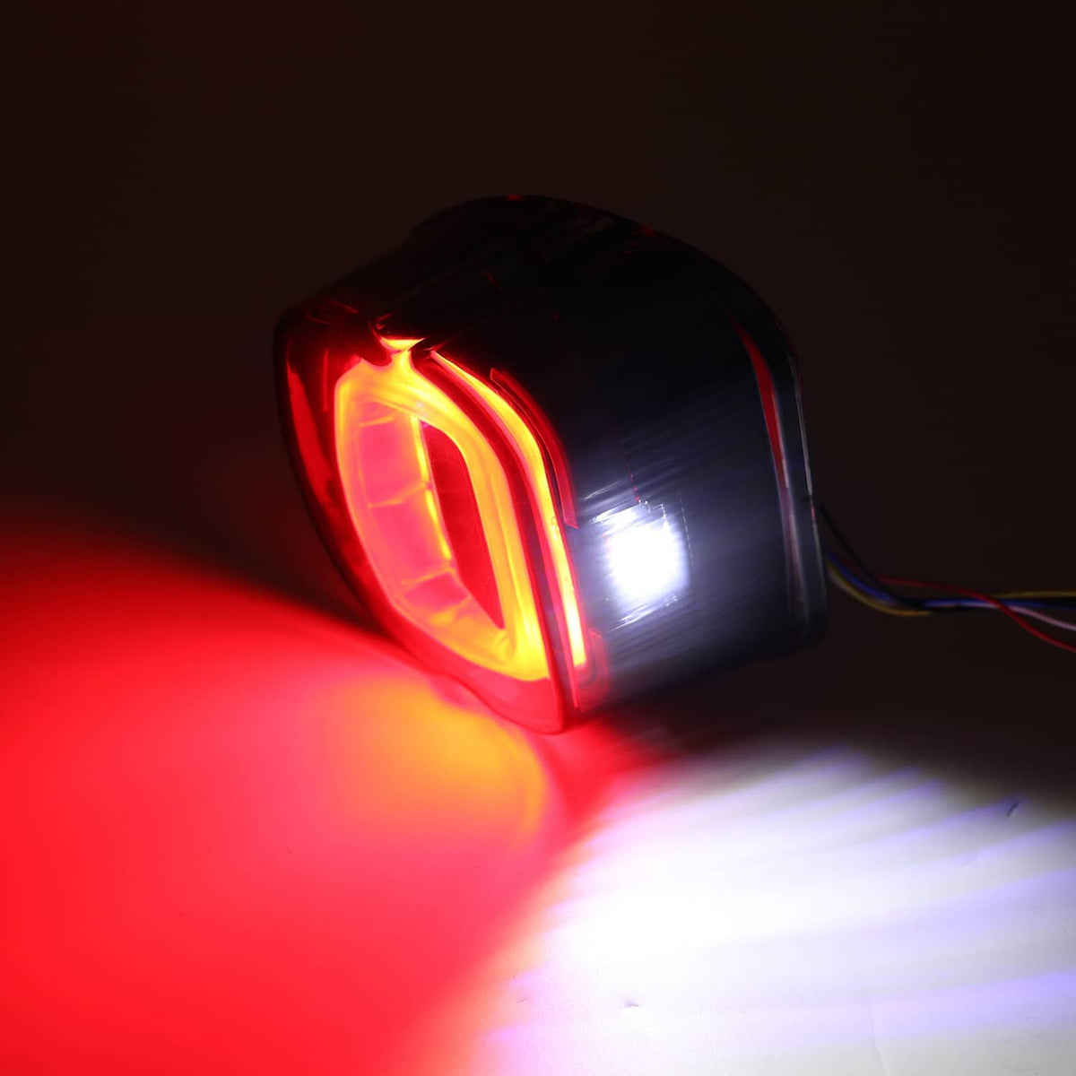 Smoked LED rear tail light with amber turn signal glow, angled side view