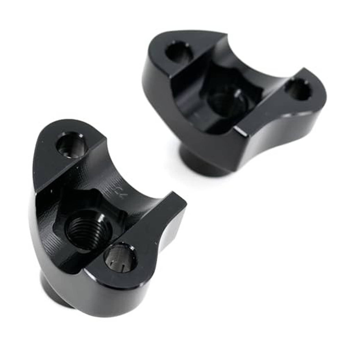 Close-up of black handlebar riser clamp blocks showing threaded insert and bolts