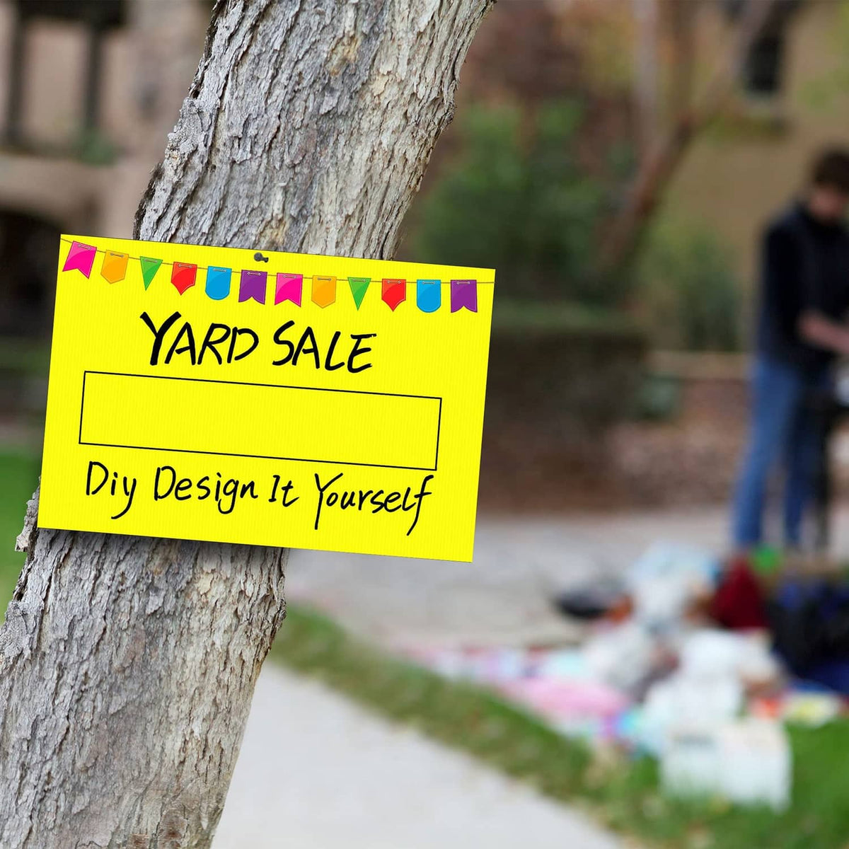 Yellow Yard Sale sign on stakes attached to a tree trunk; DIY Design It Yourself