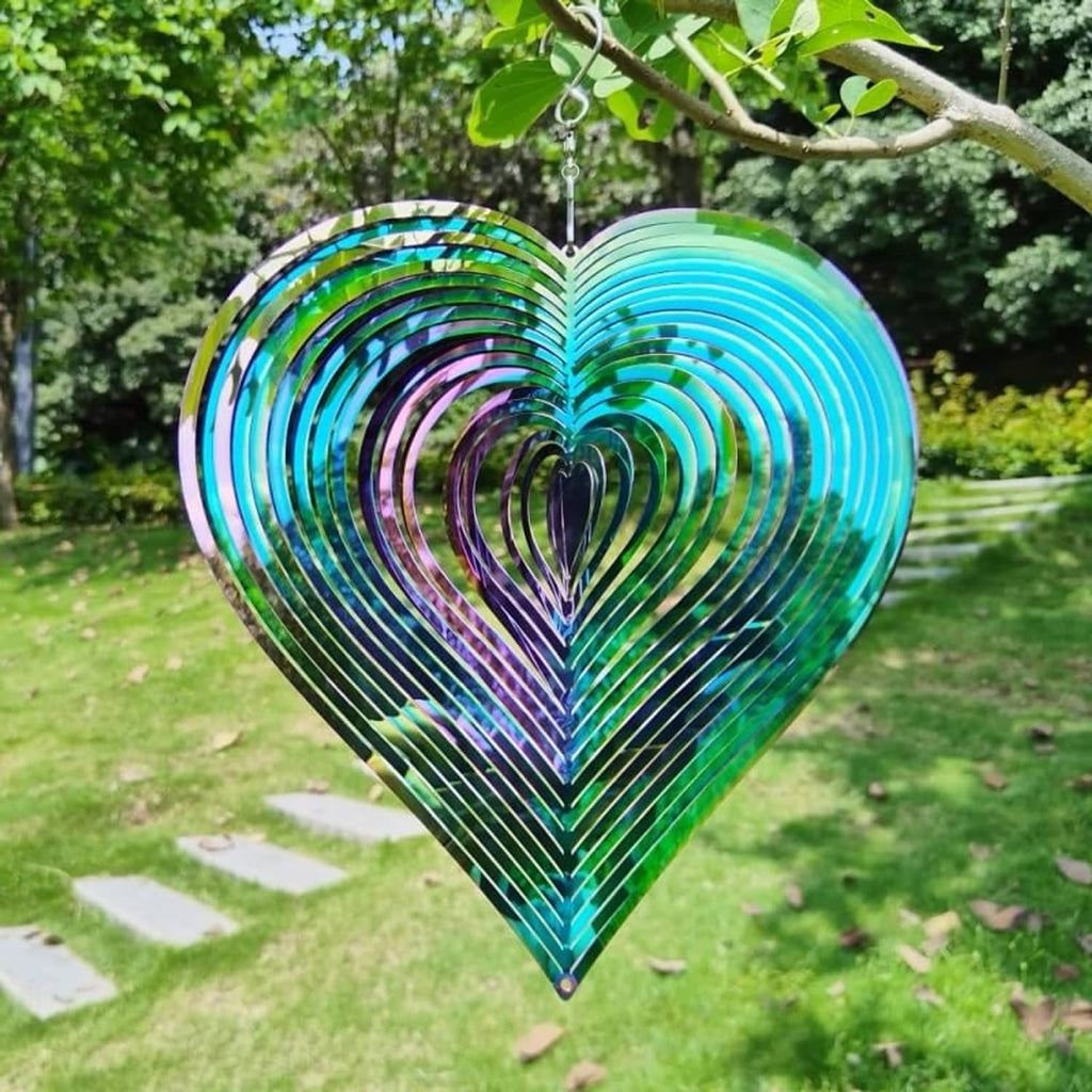 Heart wind chime spinner with blue outer rings, dark center, and colorful iridescent stripes