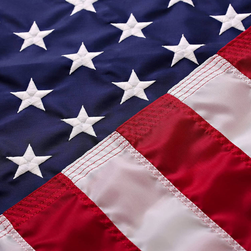 American flag set with blue star field, red stripes, and stitched fabric edge