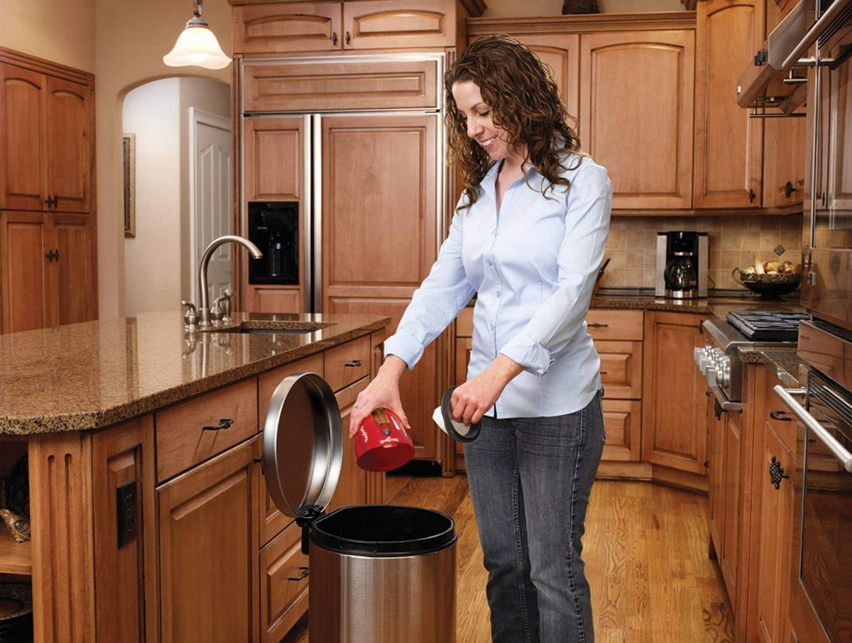 Red handheld vacuum used in kitchen, handheld unit over countertop area