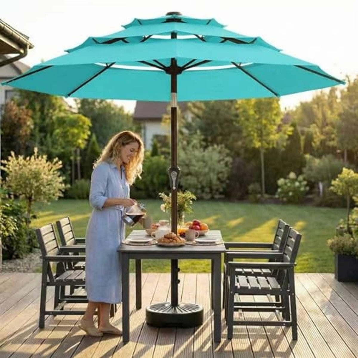 Aqua blue 3-tier patio umbrella with solar LED lights over an outdoor dining table set.