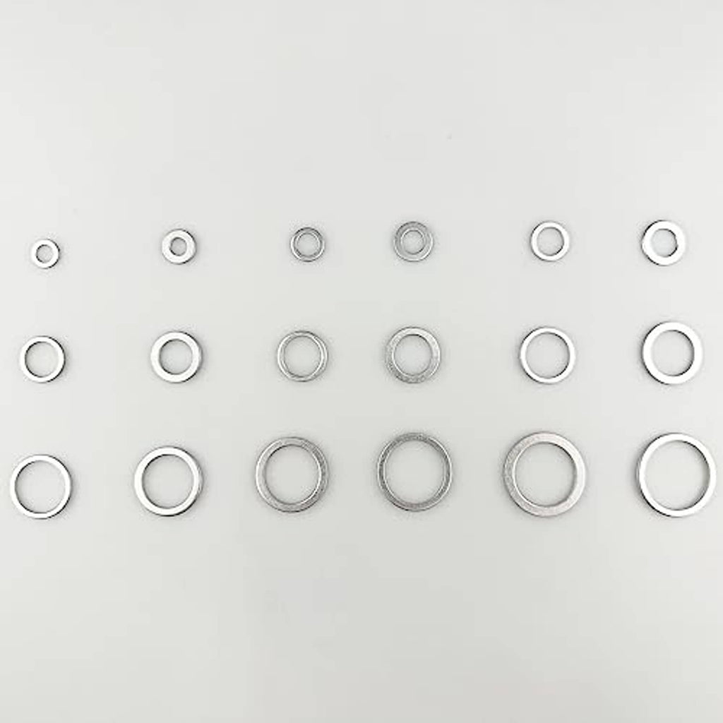 Assorted round aluminum oil drain plug gaskets arranged in rows, silver metal washers
