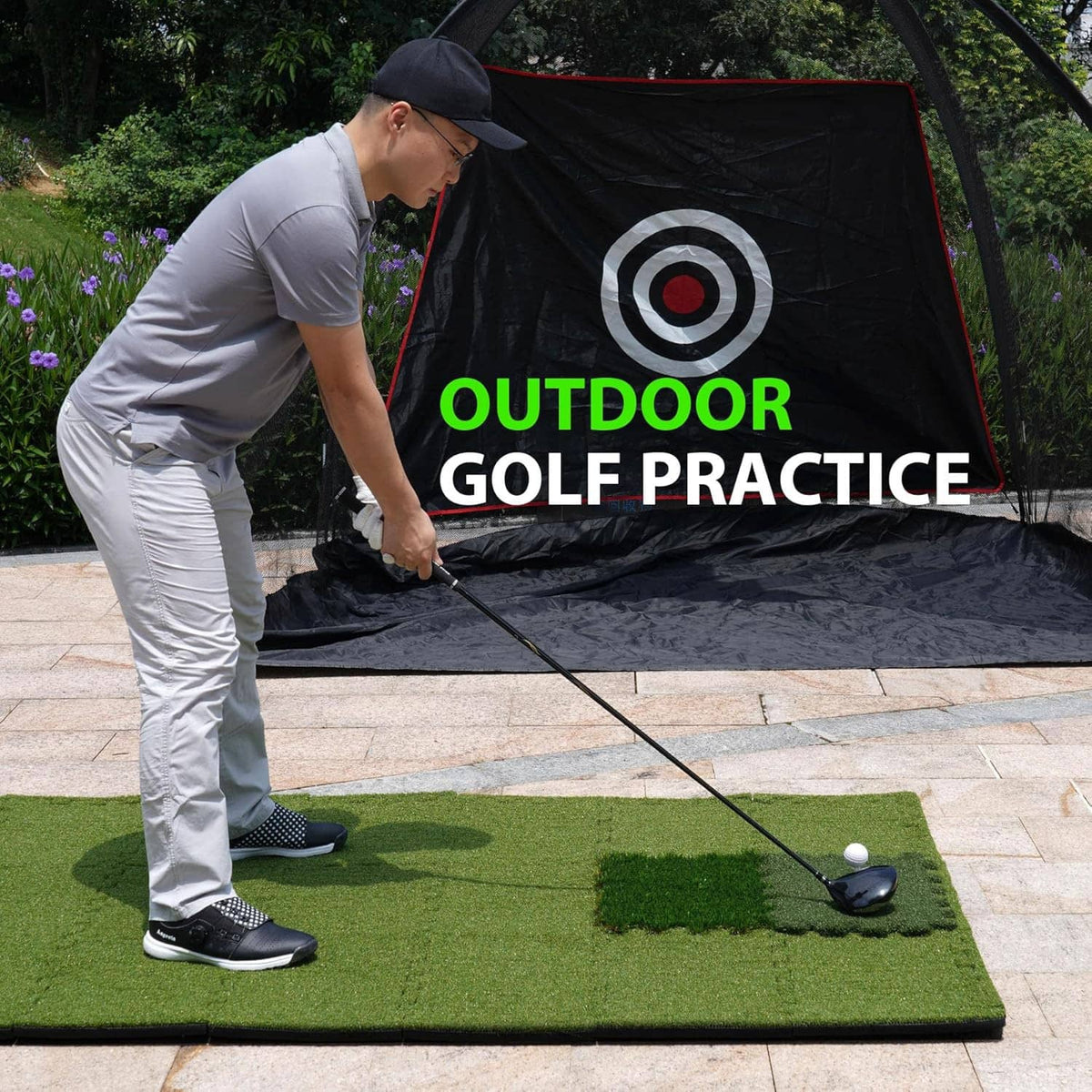 Tri-turf golf hitting mat with golfer stance and ball on the green hitting area for outdoor practice