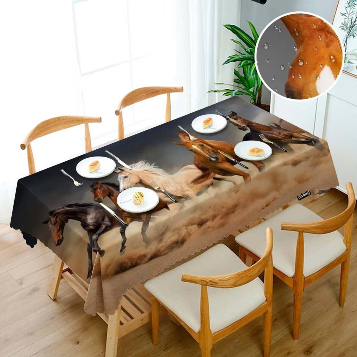Rectangular horse-print tablecloth covering dining table with plates and chairs