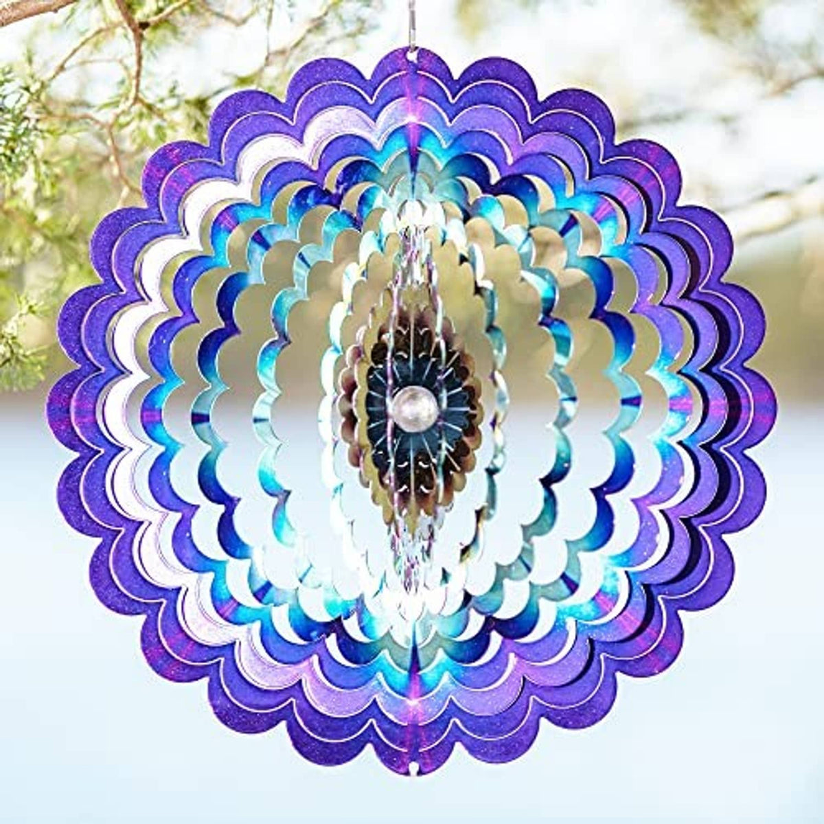 Hanging floral wind spinner with purple-blue layered petals and central metal medallion