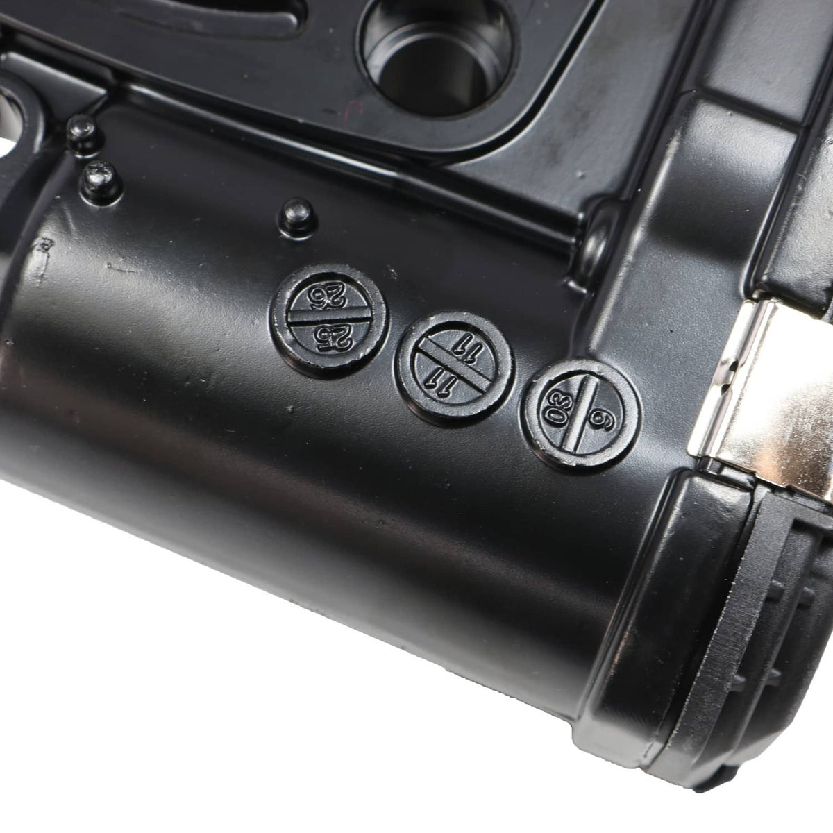 Throttle body close-up of black casing with molded icons and connector interface