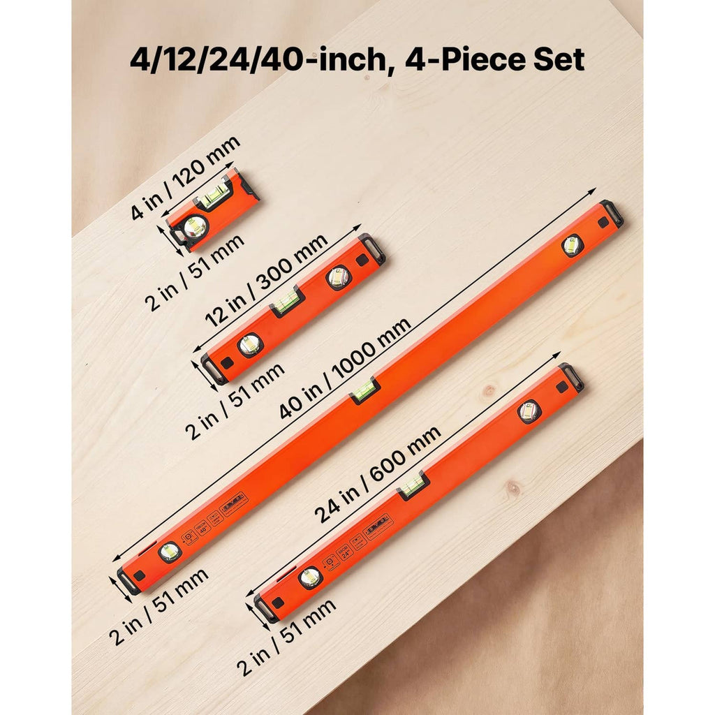 Four-piece orange torpedo level set laid on wood, showing multiple lengths and vial windows