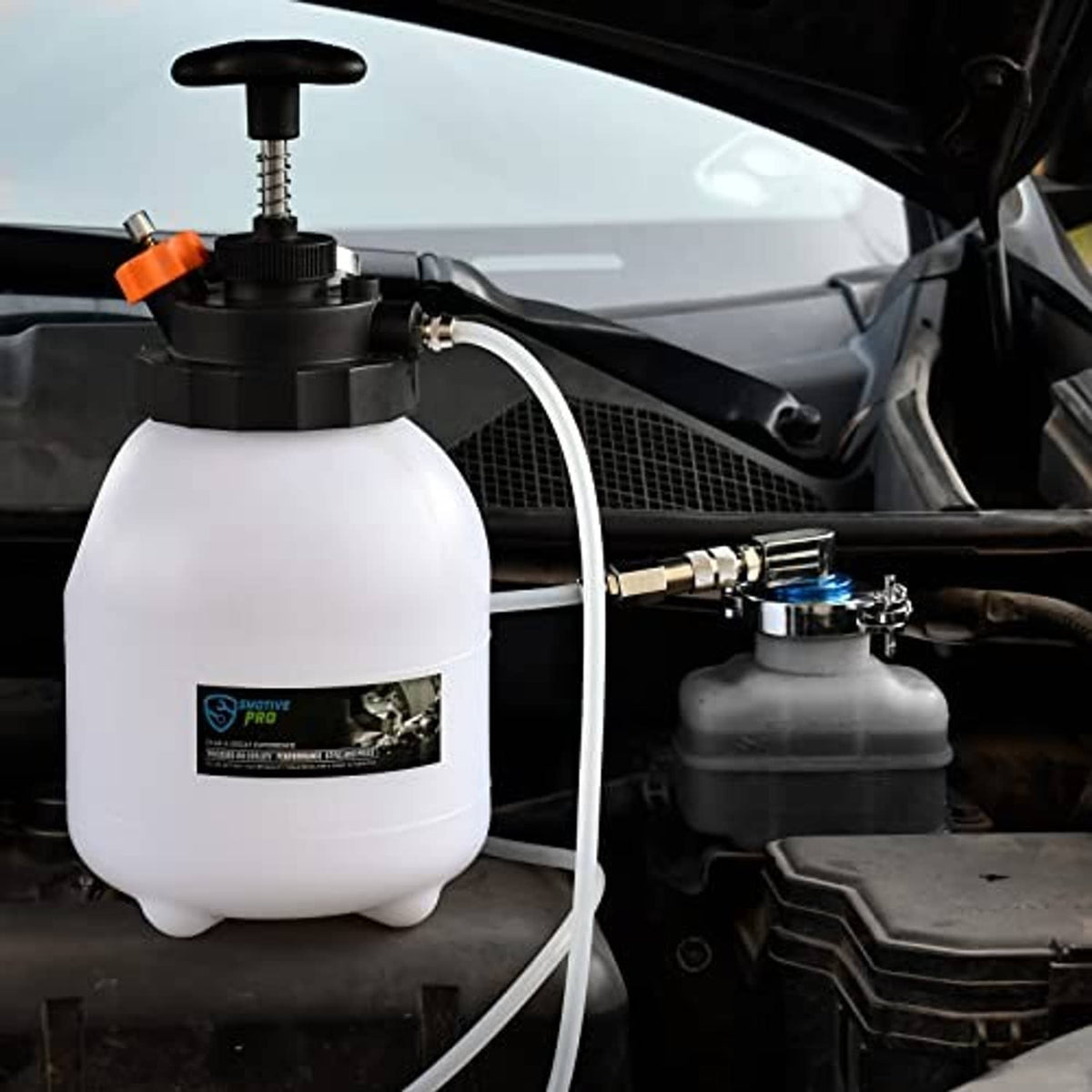 Brake bleeder adapter connected to the master cylinder with vacuum bottle setup