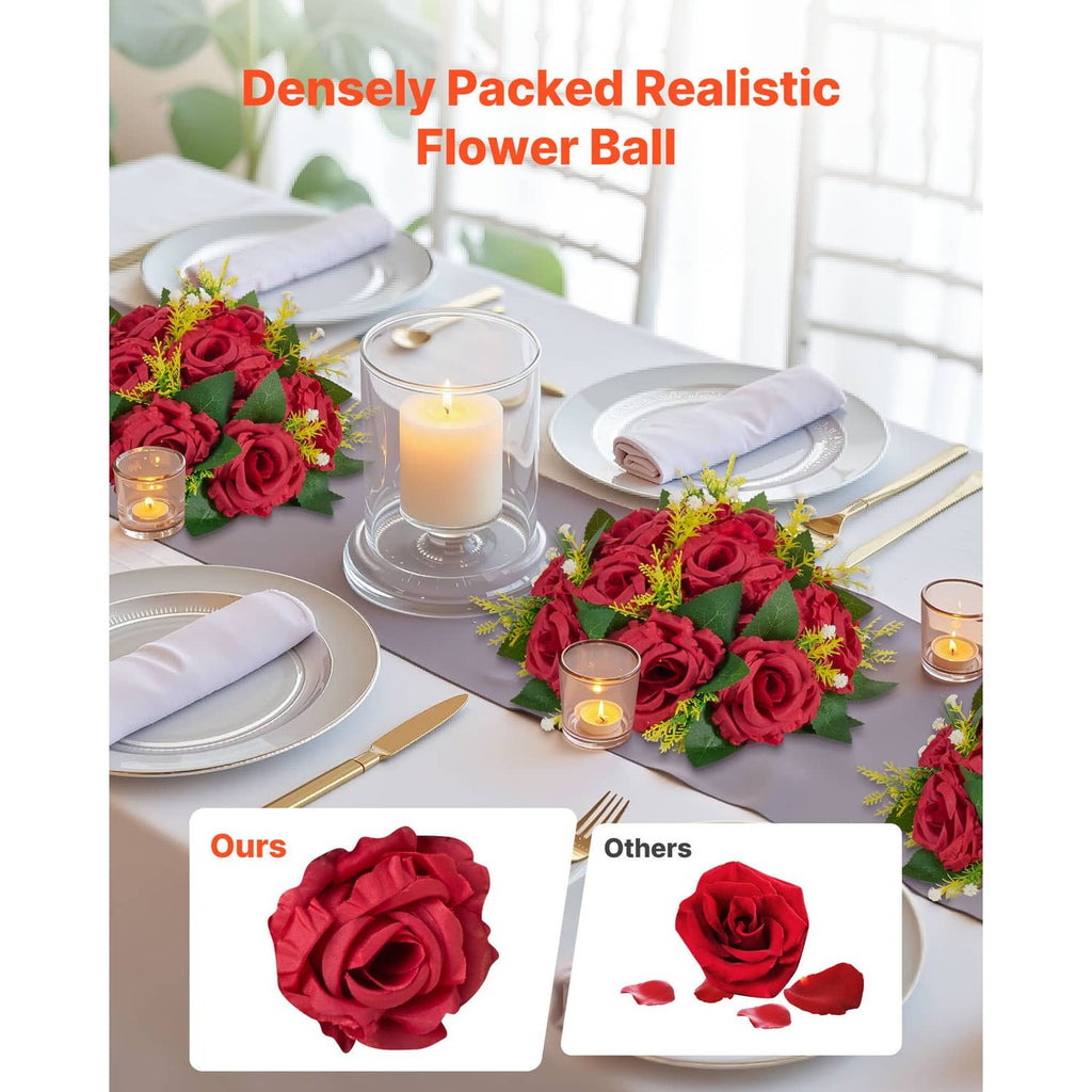 Red artificial flower ball centerpieces on a banquet table with candles and place settings