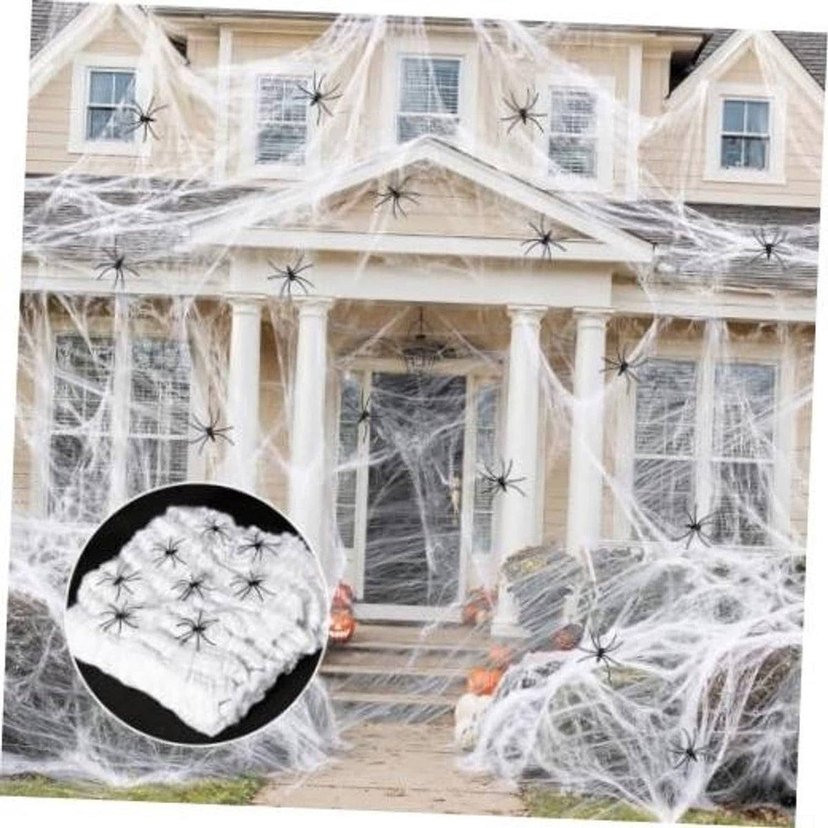 White spider web decor with black spiders, draped across outdoor house facade