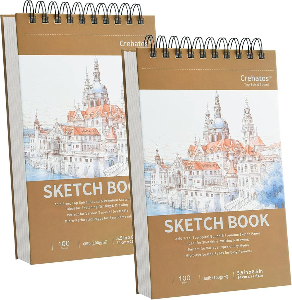 Two small spiral-bound sketch pads with illustrated city covers, 100 sheets