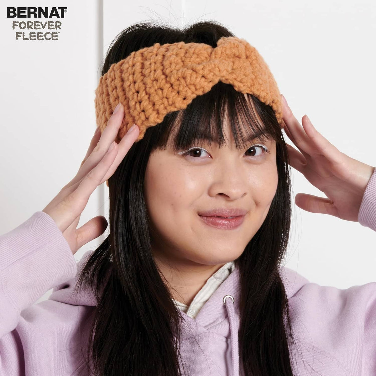 Chunky knit headband scarf in warm brown, worn over long dark hair