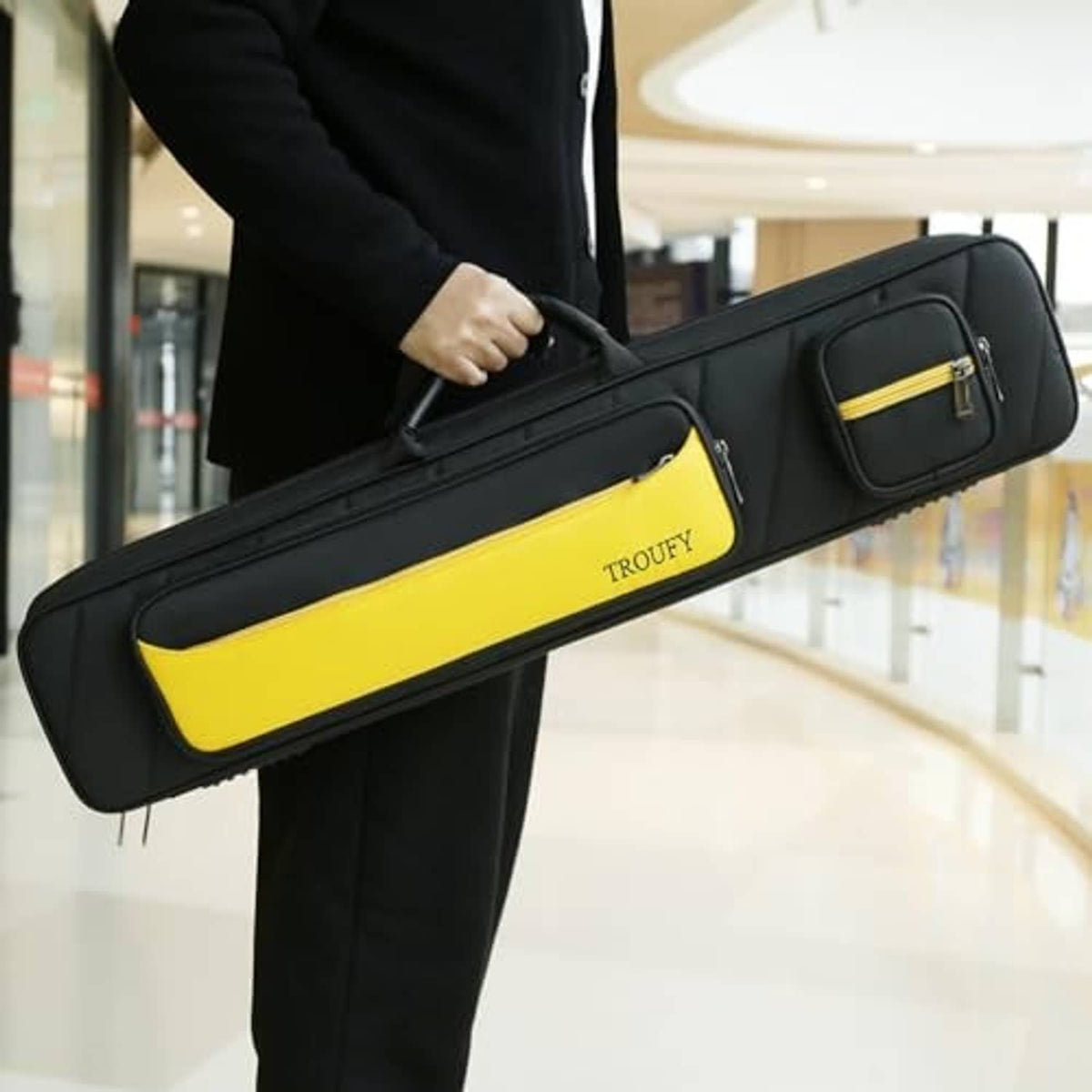 Black and yellow pool cue case held by a person with handle and zip pocket