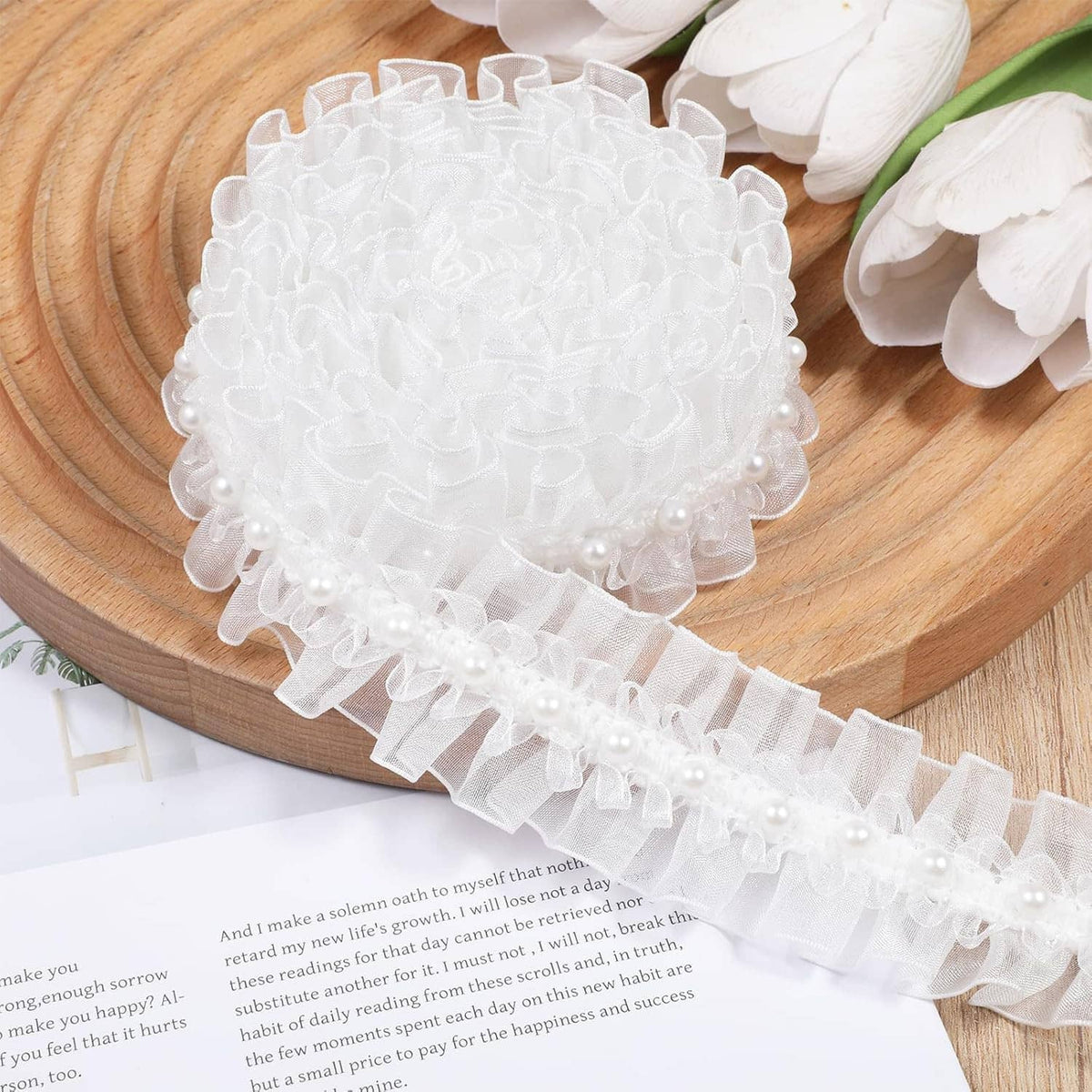 White pearl lace ruffle trim with layered scallops and bead row, coiled on wood