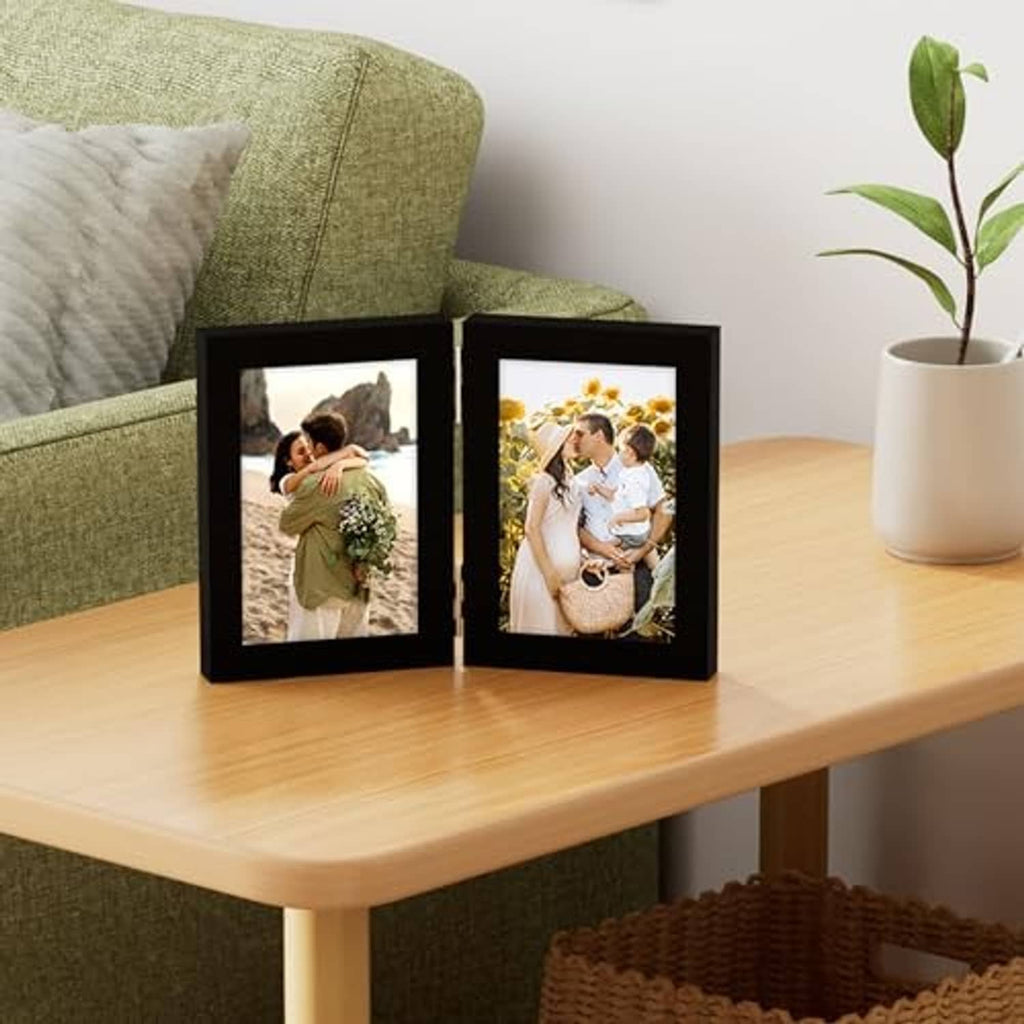 Black double vertical photo frame on tabletop, displaying two 4x6 portraits