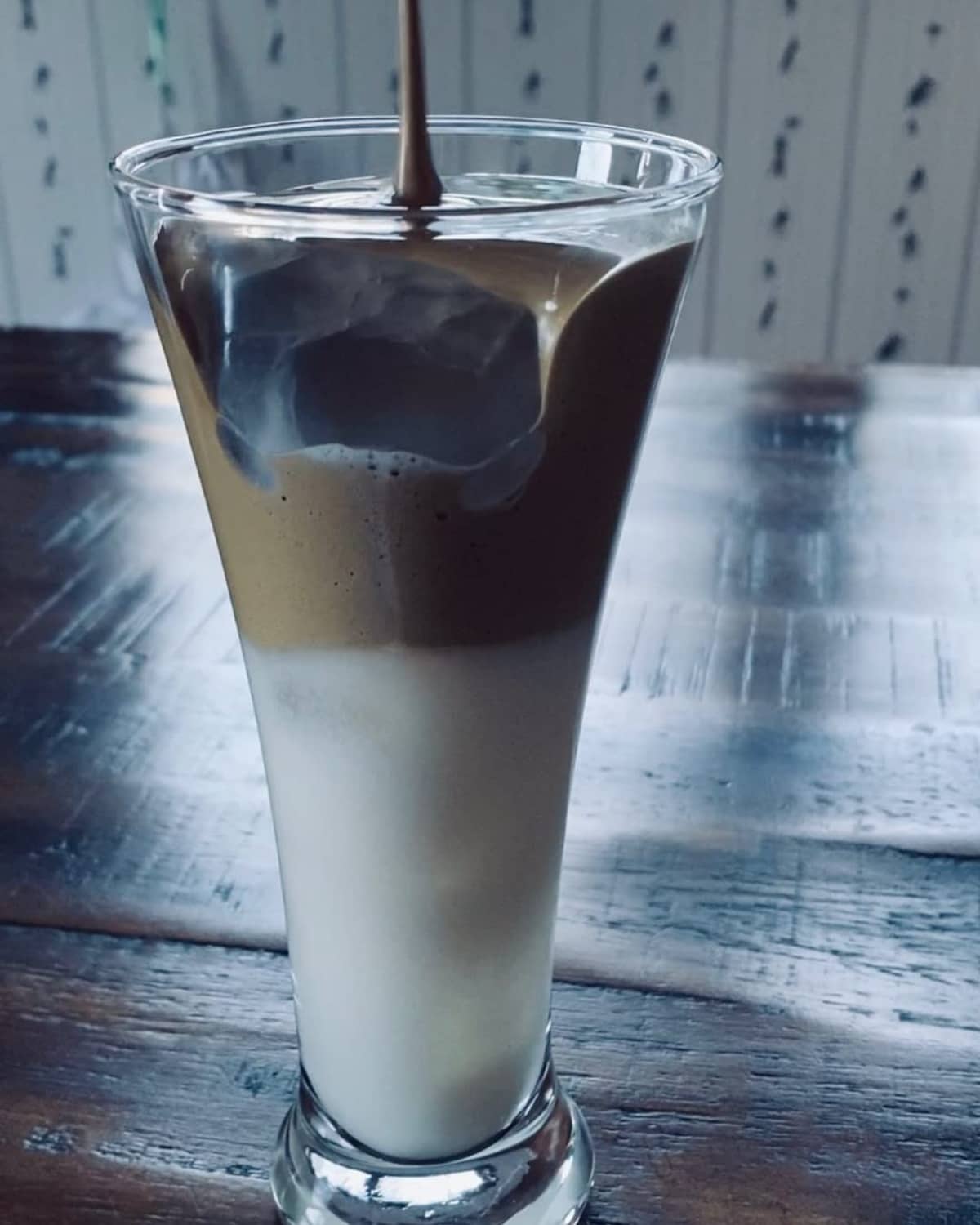 Tall glass of creamy instant herbal beverage with light foam