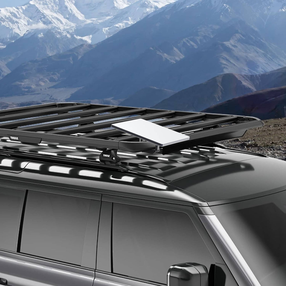 Gray roof rack mount plate secured to roof crossbars on a vehicle