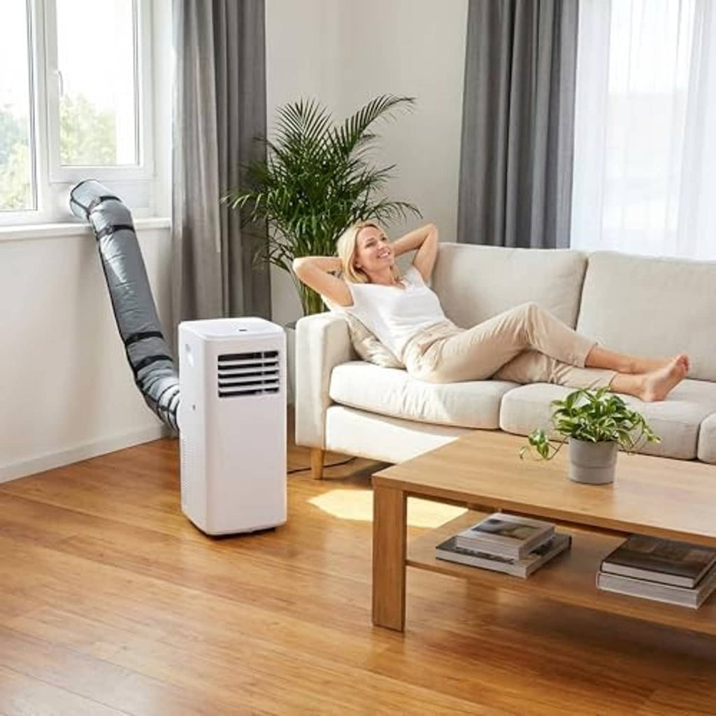 Dark grey insulated AC exhaust hose cover on a portable unit in a living room