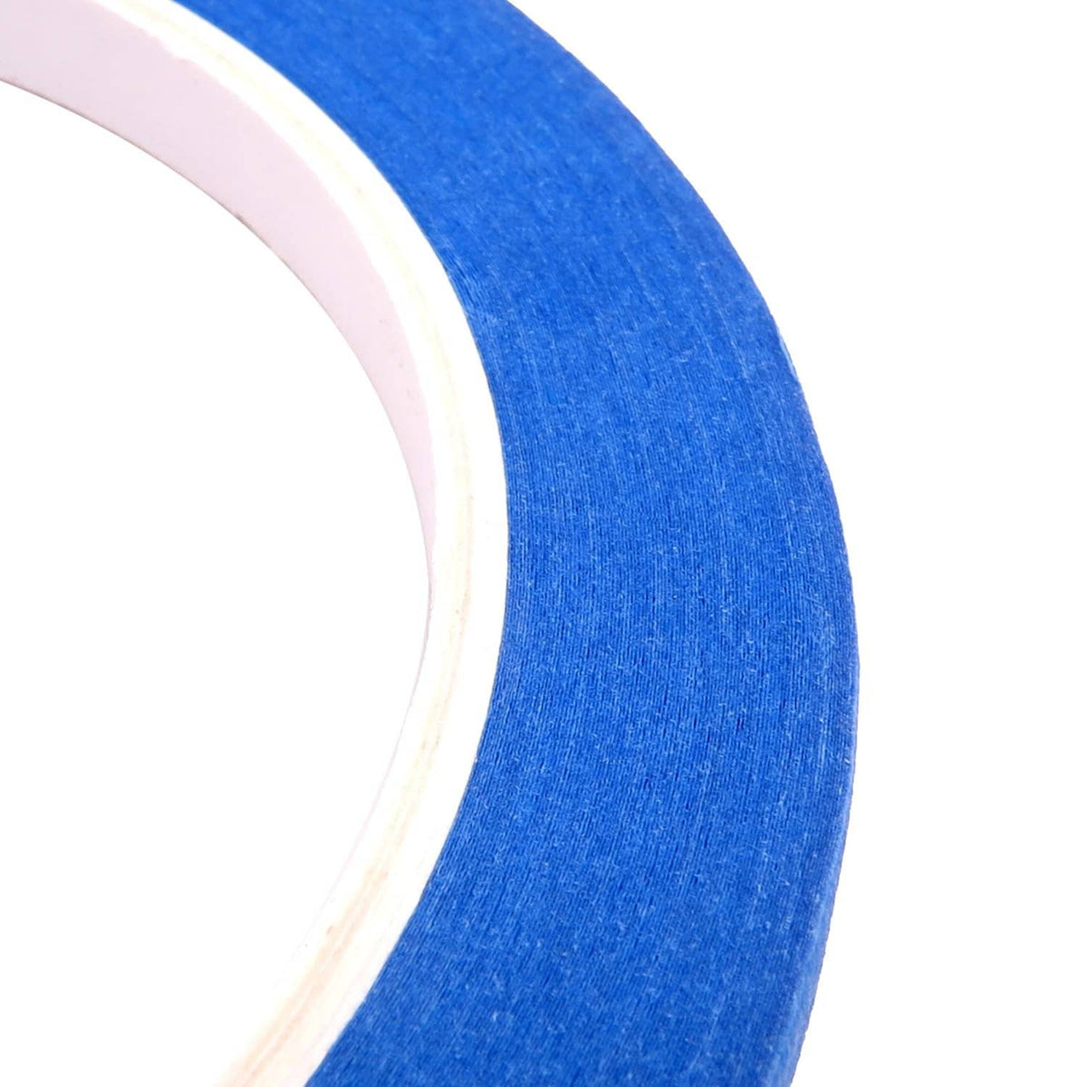Close-up of blue painter's tape edge, showing layered paper backing and thickness.