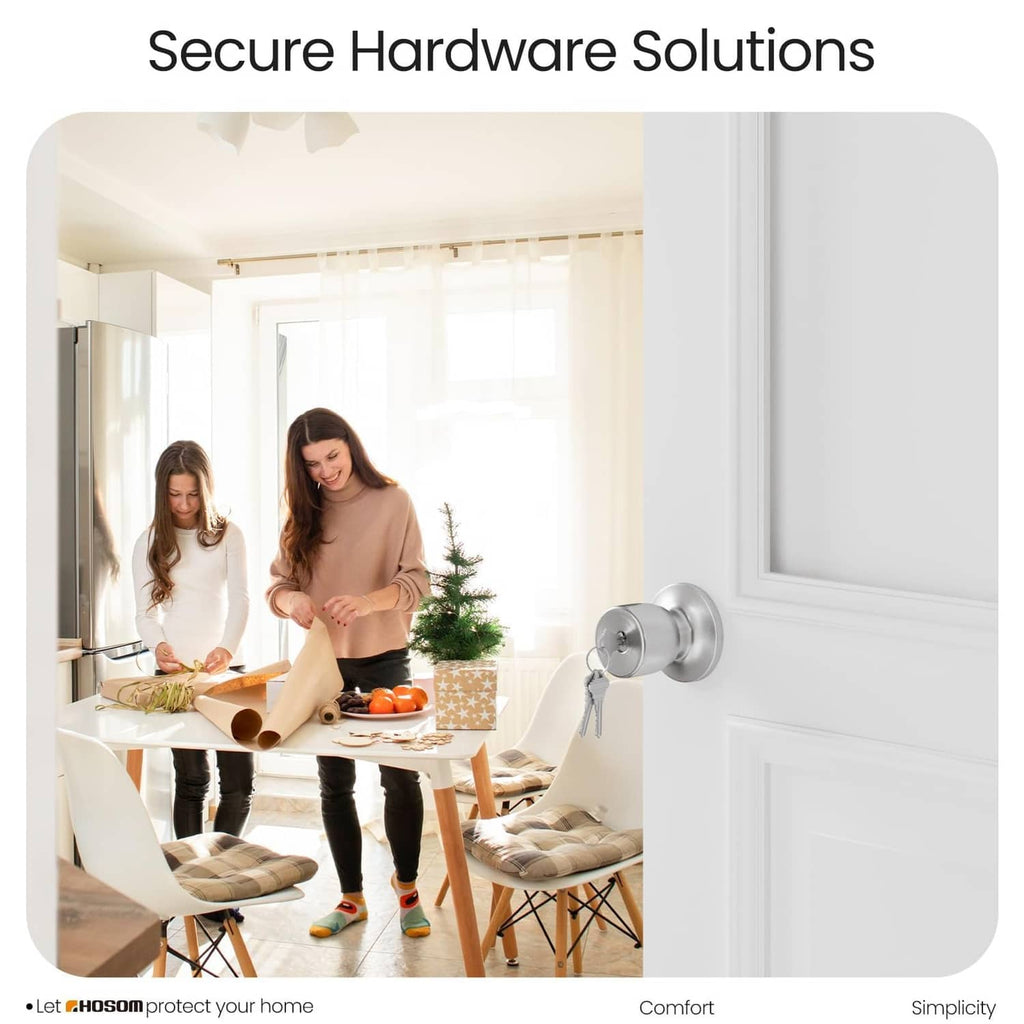 Satin nickel keyed entry door knob lock on front door with key held ready
