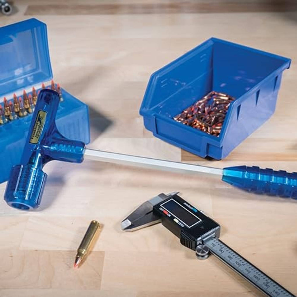 Blue impact bullet puller with metal shaft beside tray of cartridges