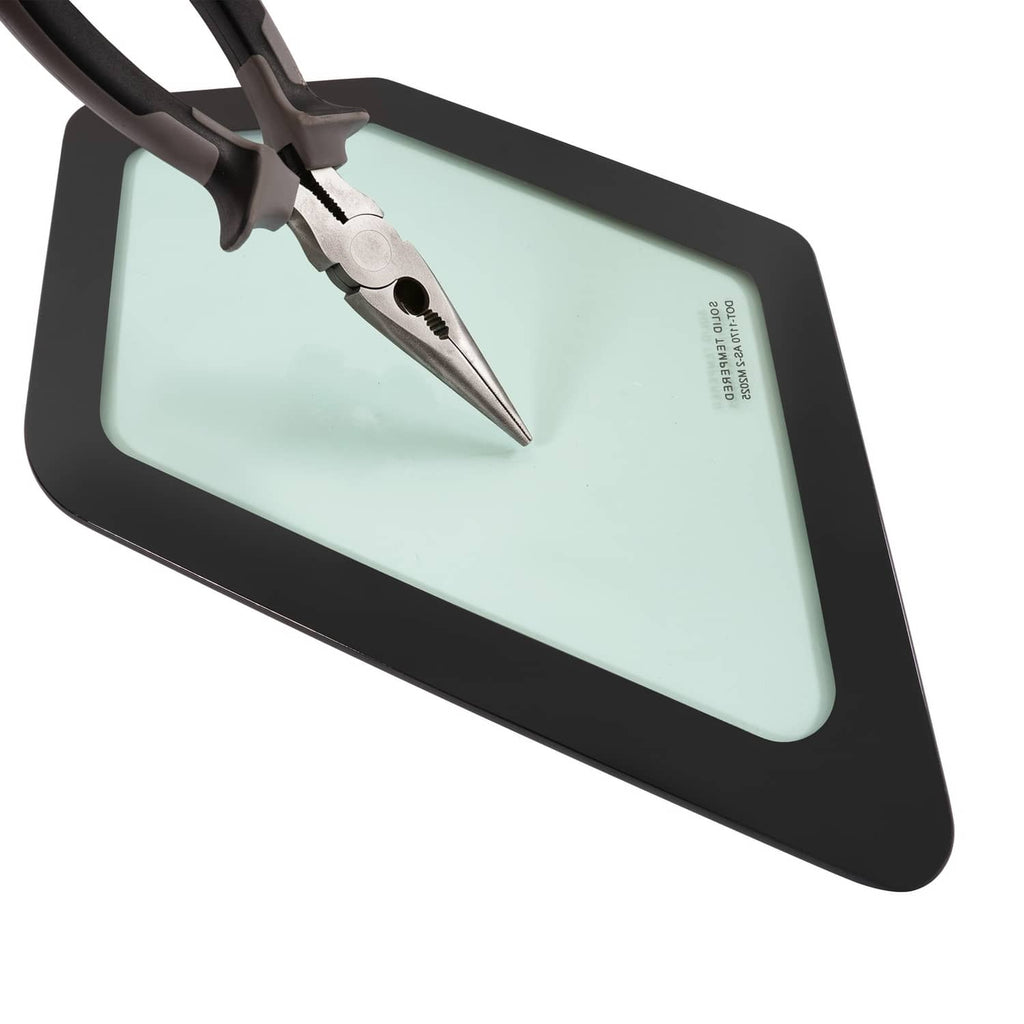 Skid steer cab window glass with black frame, light green tint, and installed tool detail