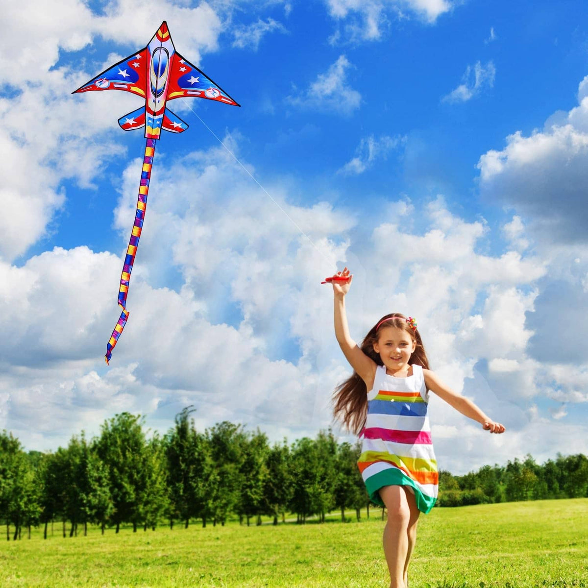 Airplane kite with red and blue star design, kid running with the kite line