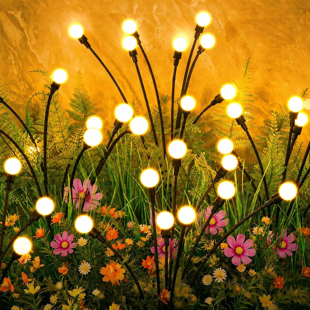 Outdoor solar garden light set with glowing round LED bulbs on black stakes