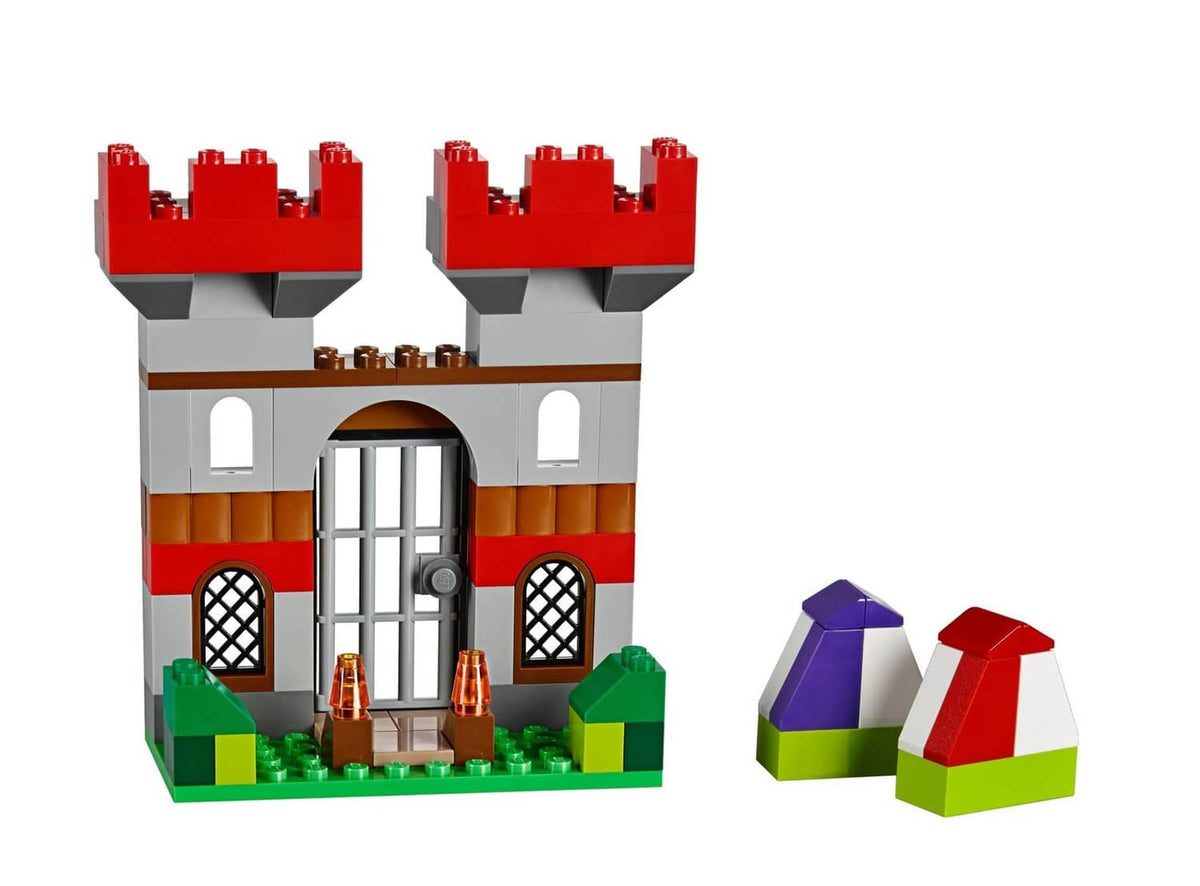 Red-roof LEGO gatehouse model with gray doors, windows, and green base