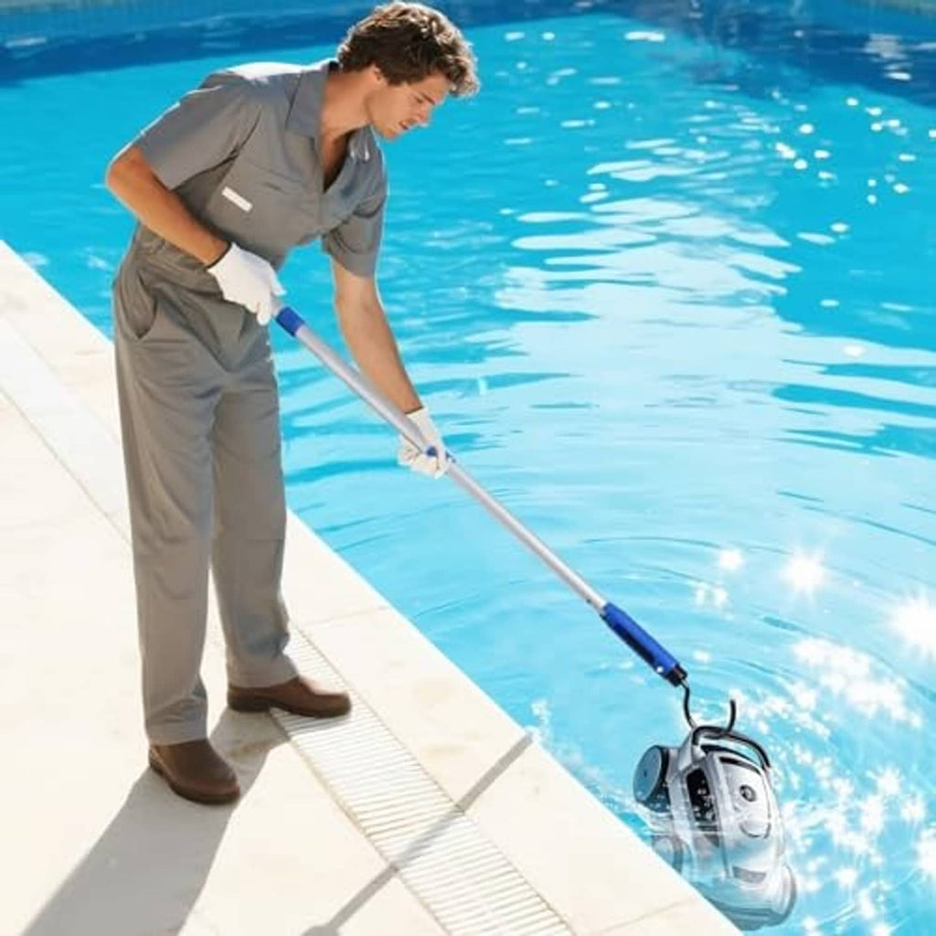 Robotic pool cleaner with long handle and blue brush head at pool edge