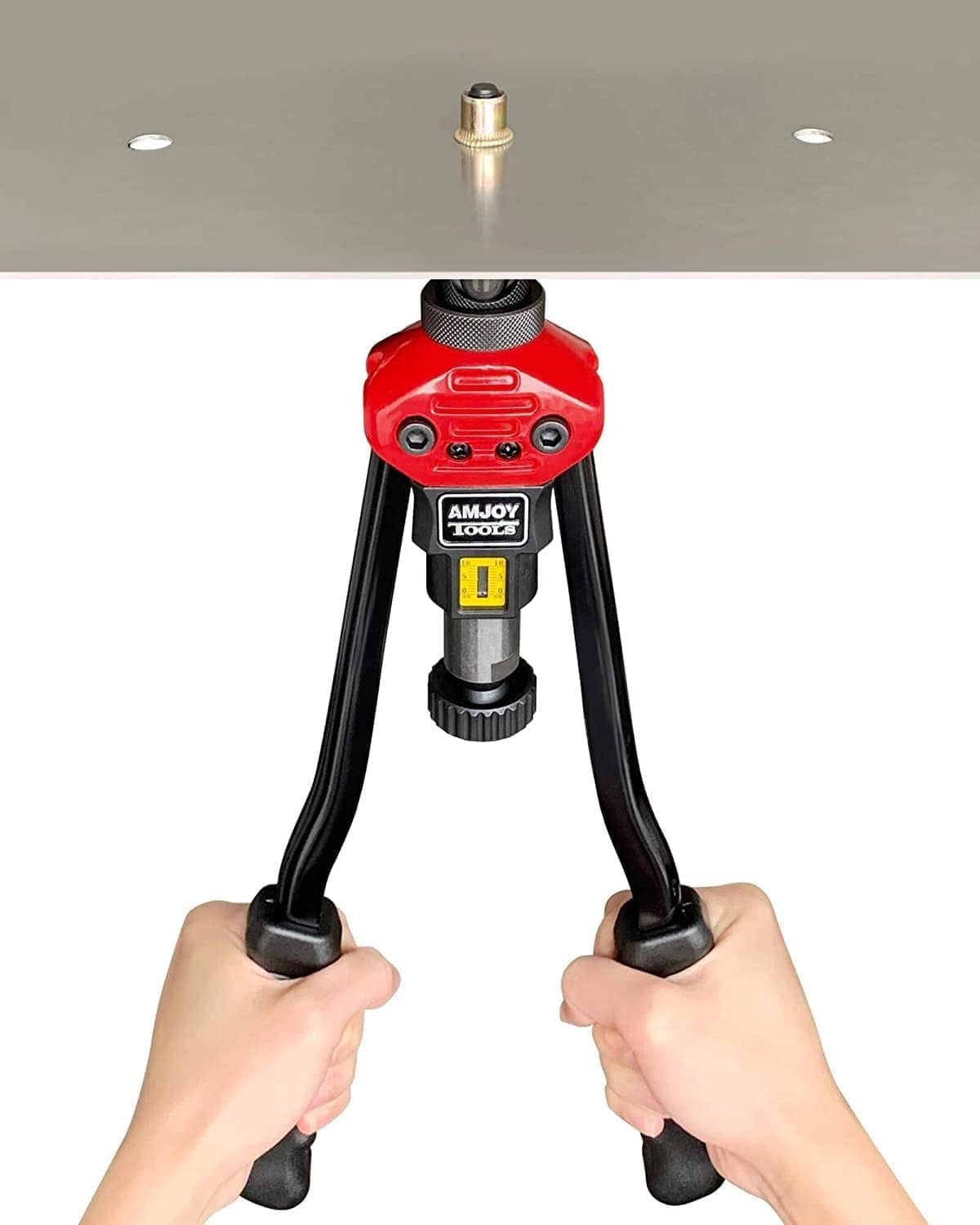 Rivet nut installation tool with mandrel tip visible, held by hands with black legs