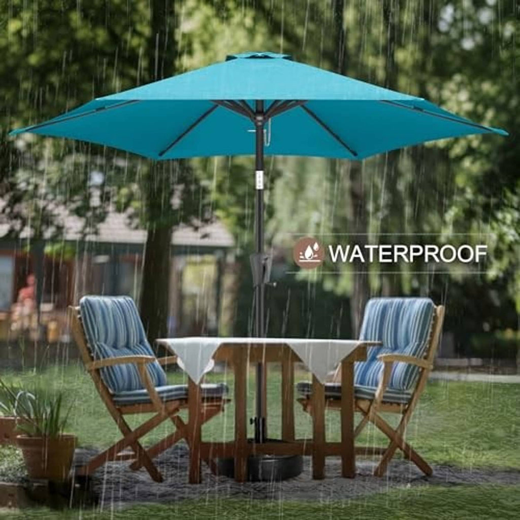 Aqua blue patio table umbrella open over outdoor dining set in garden
