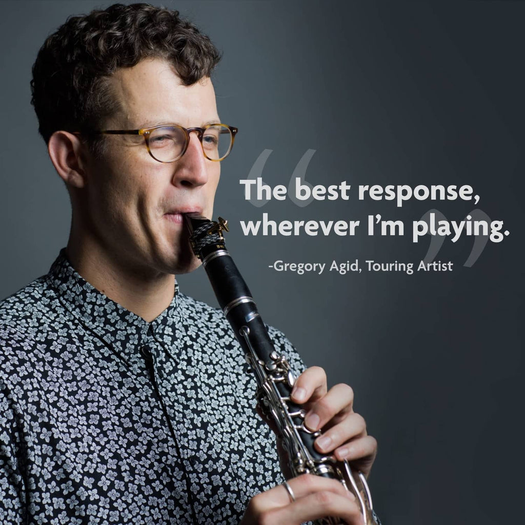 Clarinet player holding a clarinet with mouthpiece near lips, promotional lifestyle photo