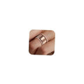 14K gold plated stacking rings on a finger, one wide band and one thin textured ring