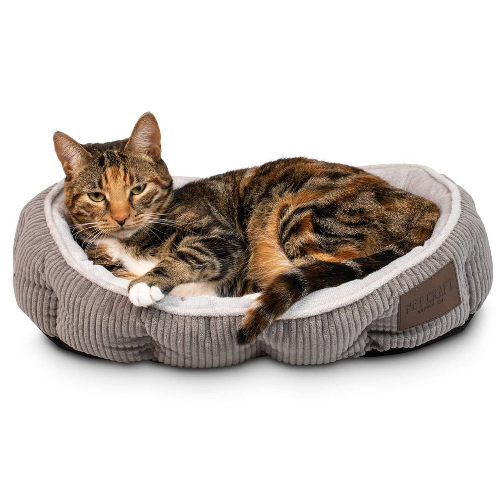 Gray ribbed round cat bed with plush lining; tabby cat resting inside