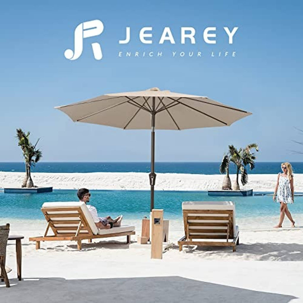 Beige patio umbrella open with crank pole and canopy above outdoor chairs