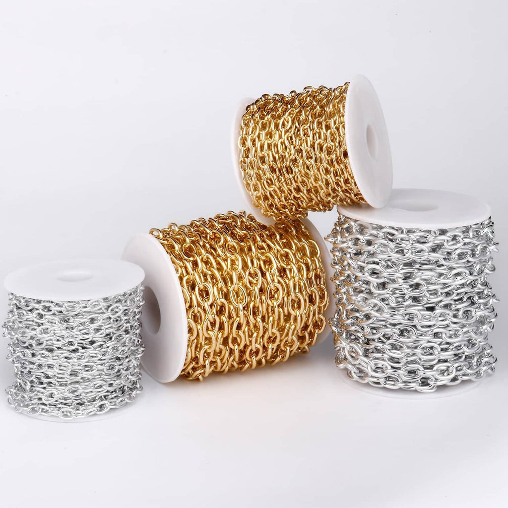 Gold and silver rolo cable chain rolls on white spools, oval links chain detail