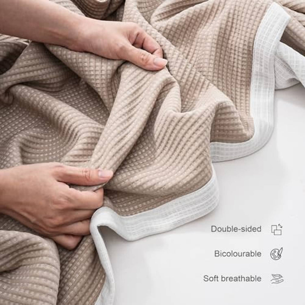 Soft microfiber double-sided blanket, khaki and white with folded textured surface.