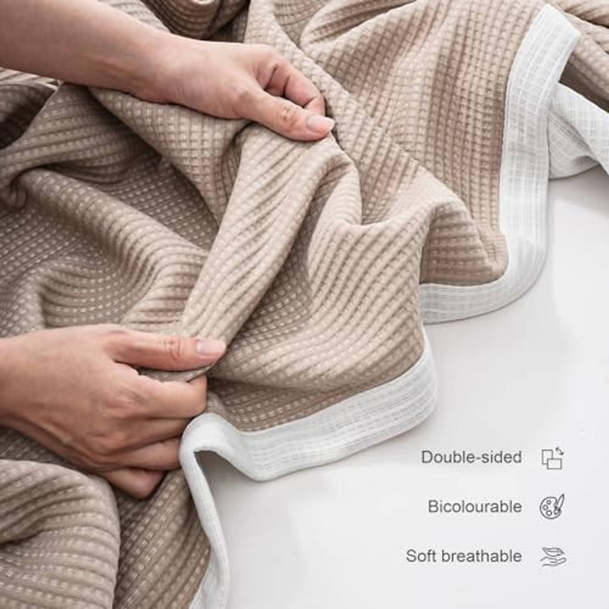 Soft microfiber double-sided blanket, khaki and white with folded textured surface.