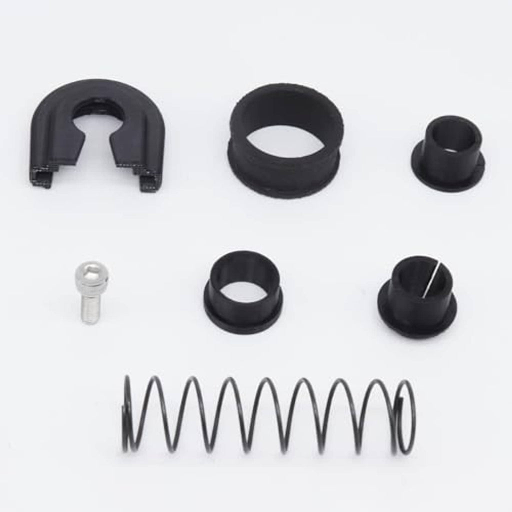 Gearbox repair kit components: several black rings, small bushings, spring and bolt