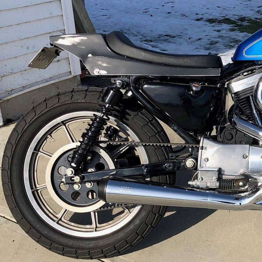 Installed adjustable rear shock absorbers on a motorcycle rear wheel area