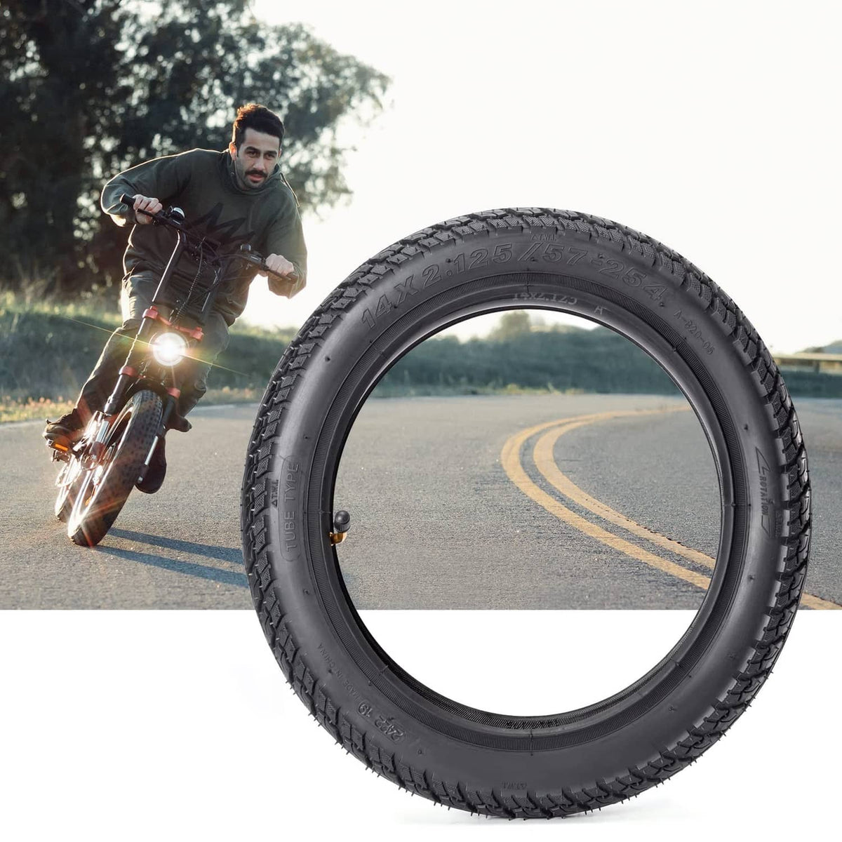 Black tire rolling outdoors with deep tread blocks and thick sidewall.