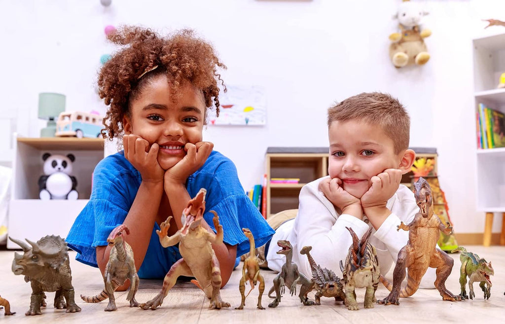 Woolly mammoth toy with ivory tusks among other dinosaur figures