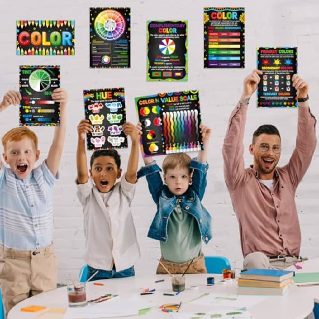 Students holding laminated color theory poster set with hue, color, and tint-shade charts