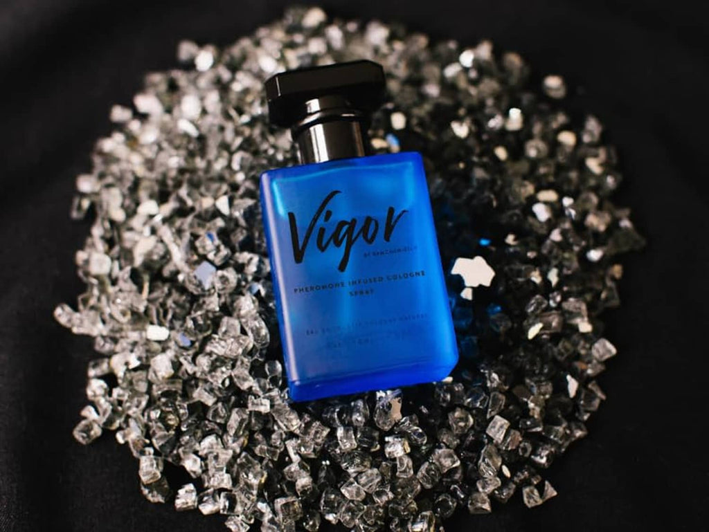 Vigor cologne bottle with black cap over silver glitter