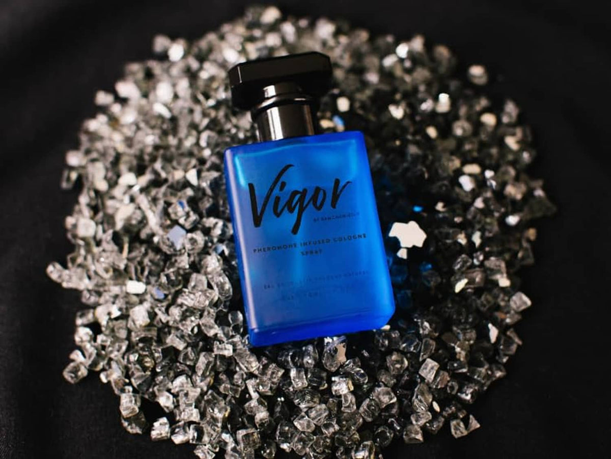 Vigor cologne bottle with black cap over silver glitter