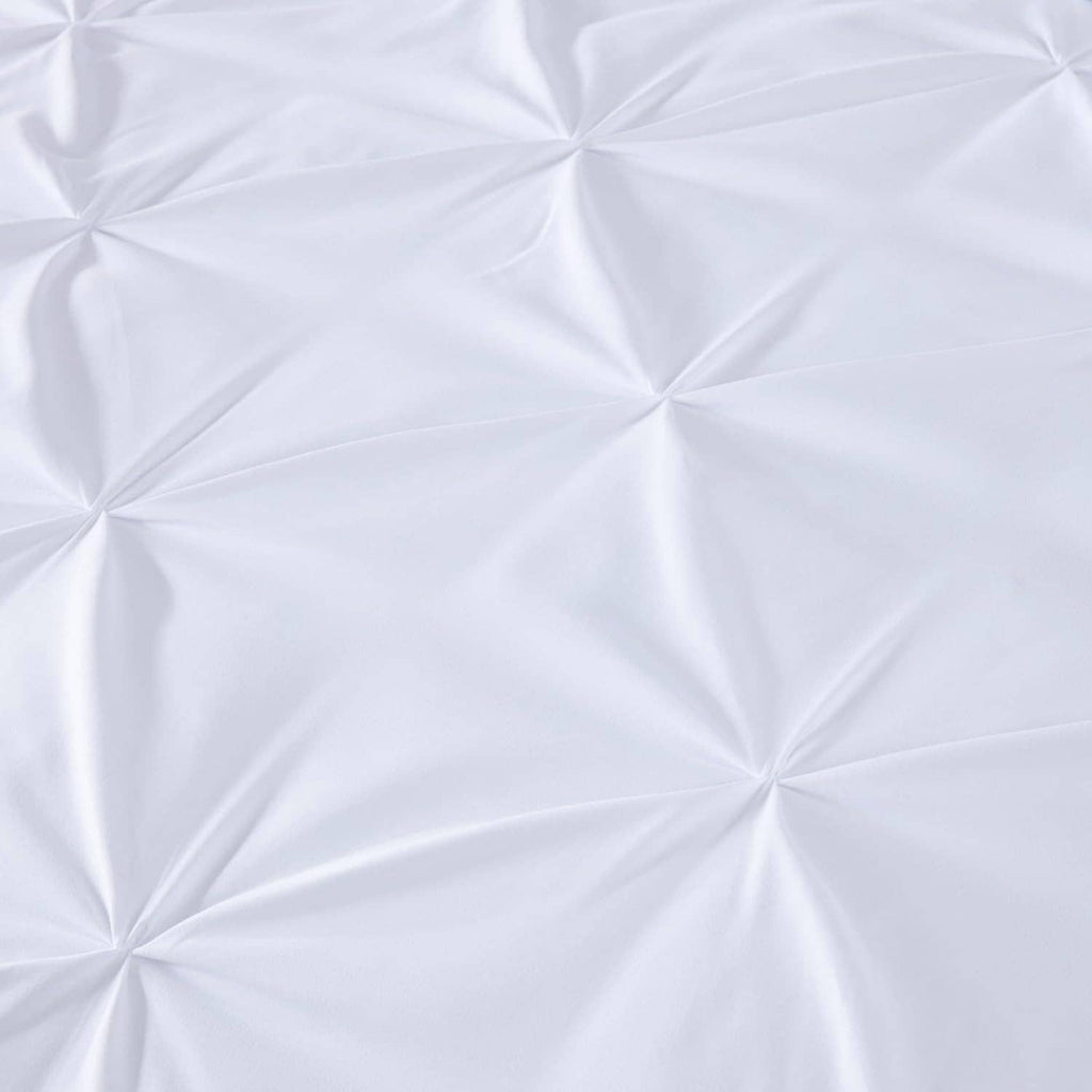 White quilted fabric panel with diamond pinch pleat texture