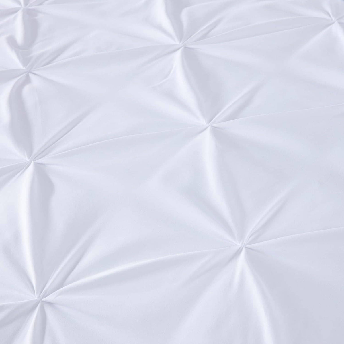 White quilted fabric panel with diamond pinch pleat texture